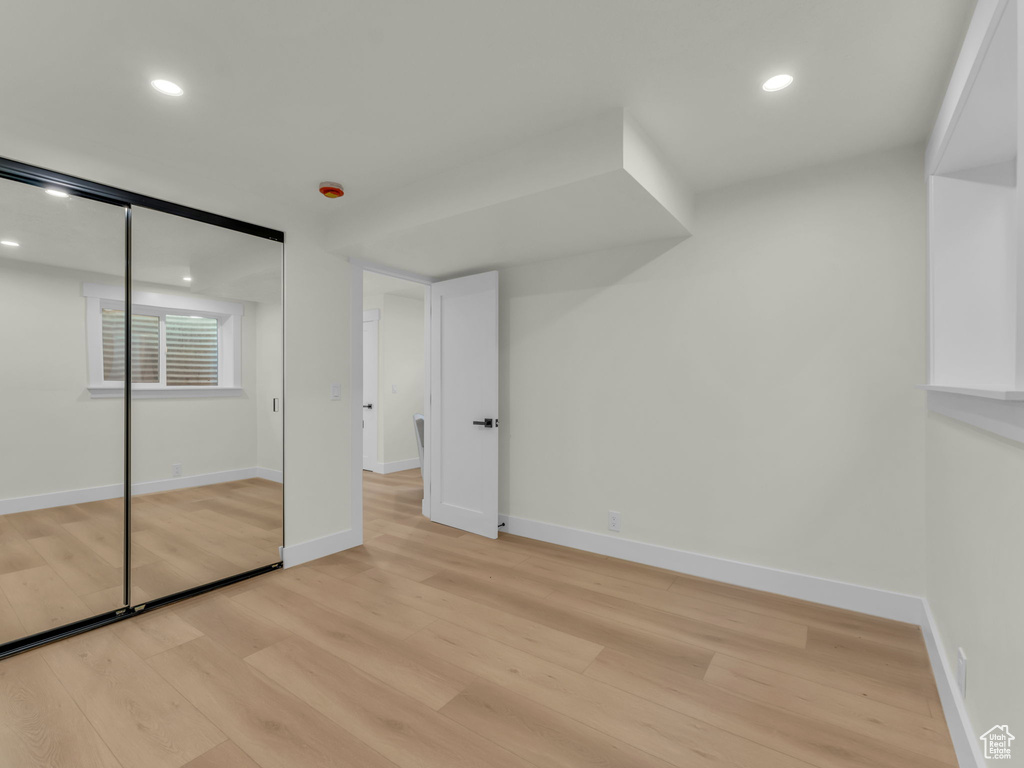 Unfurnished bedroom featuring light wood-style floors, recessed lighting, baseboards, and a closet