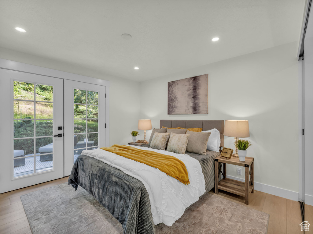 Bedroom with access to outside, wood finished floors, french doors, recessed lighting, and baseboards