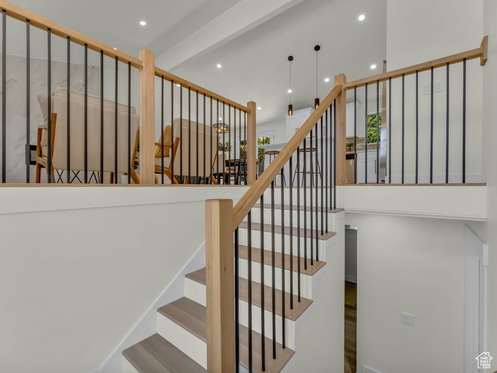 Stairs featuring recessed lighting, a towering ceiling, and plenty of natural light