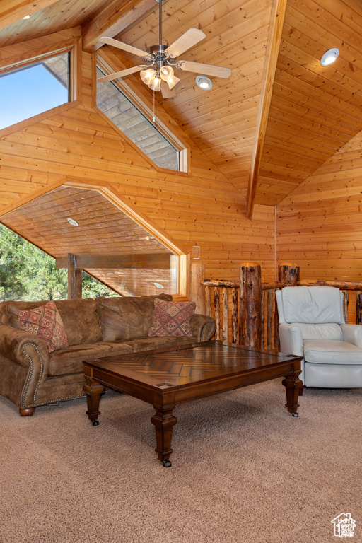 Living area with beam ceiling, wooden walls, carpet flooring, and wooden ceiling