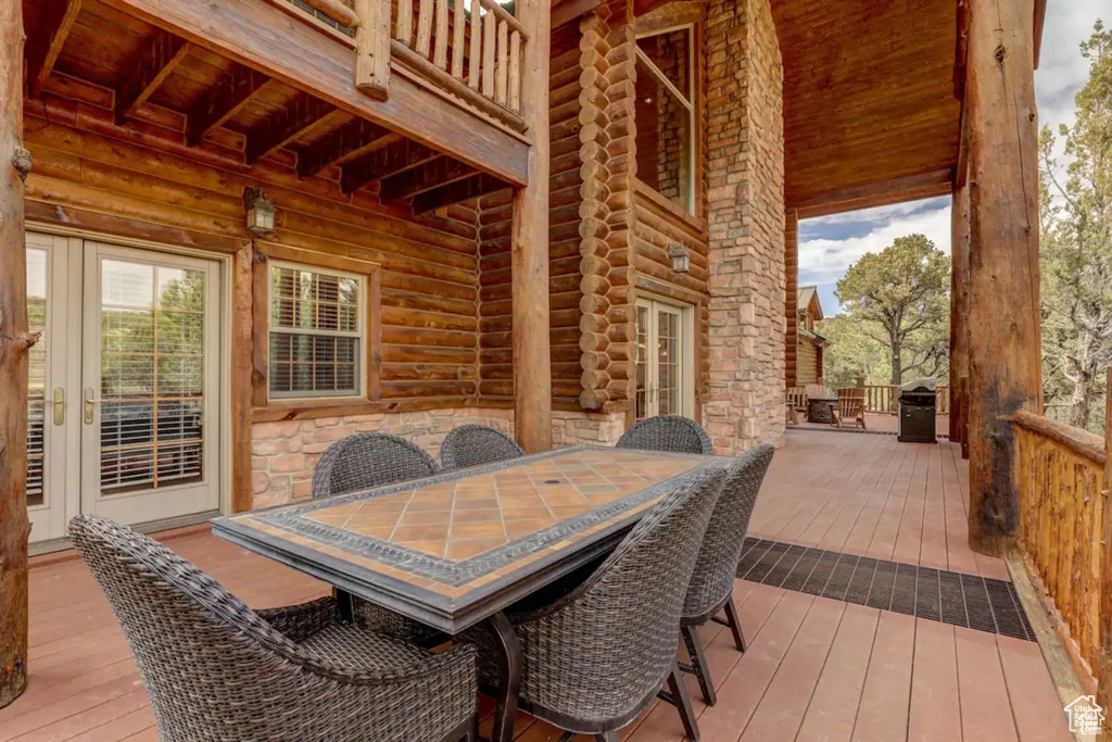 Deck featuring outdoor dining area and french doors