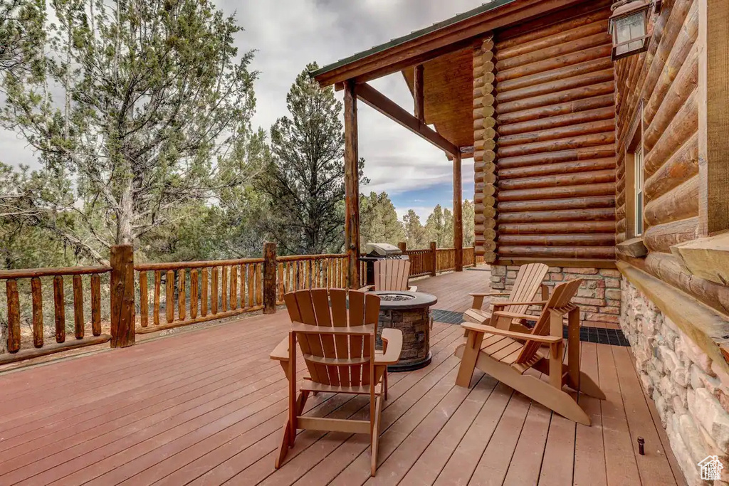 Wooden deck featuring a fire pit