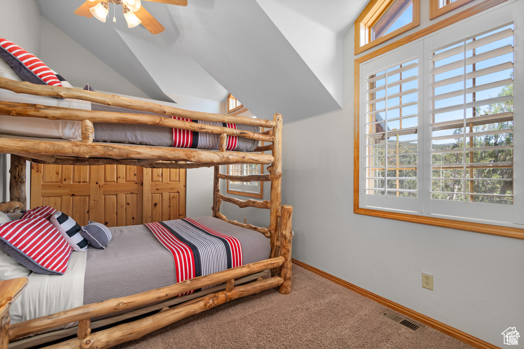 Carpeted bedroom featuring baseboards and visible vents
