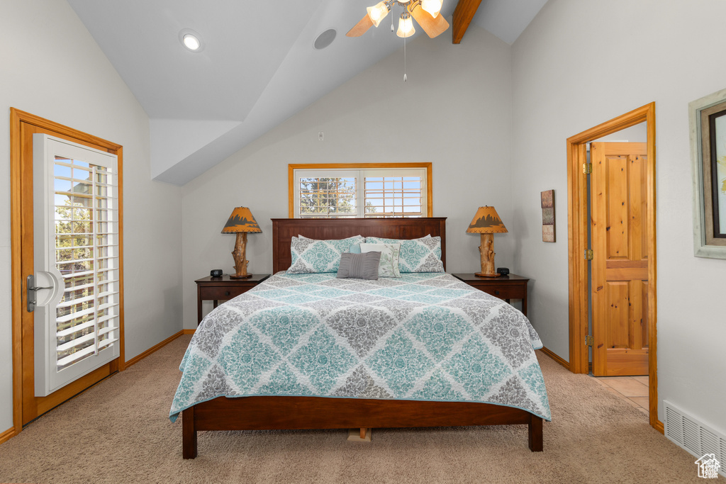 Bedroom featuring visible vents, baseboards, light colored carpet, and vaulted ceiling