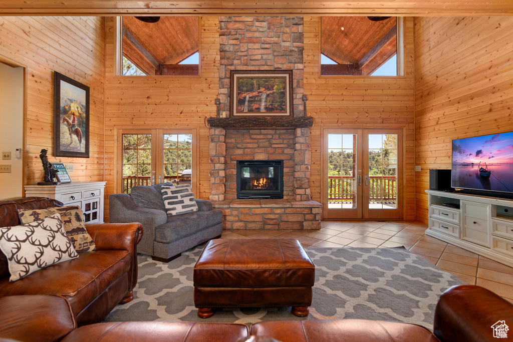 Living room featuring a wealth of natural light, french doors, and wooden ceiling