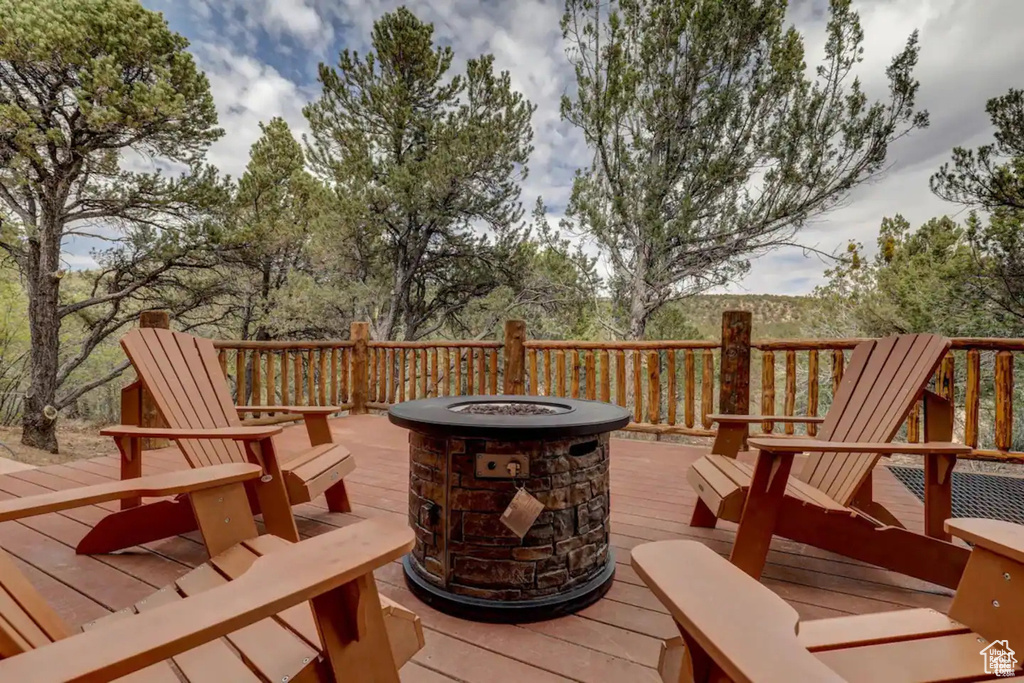 Wooden terrace featuring an outdoor fire pit