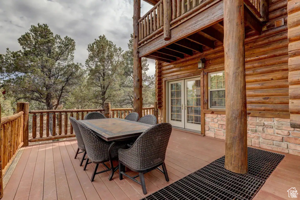 Wooden terrace featuring french doors and outdoor dining area