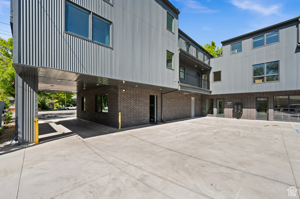 View of home's exterior with a carport, brick siding, and concrete driveway