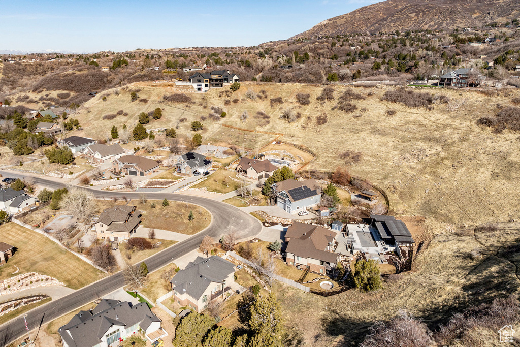 Aerial view of property's location with nearby suburban area and a mountain backdrop