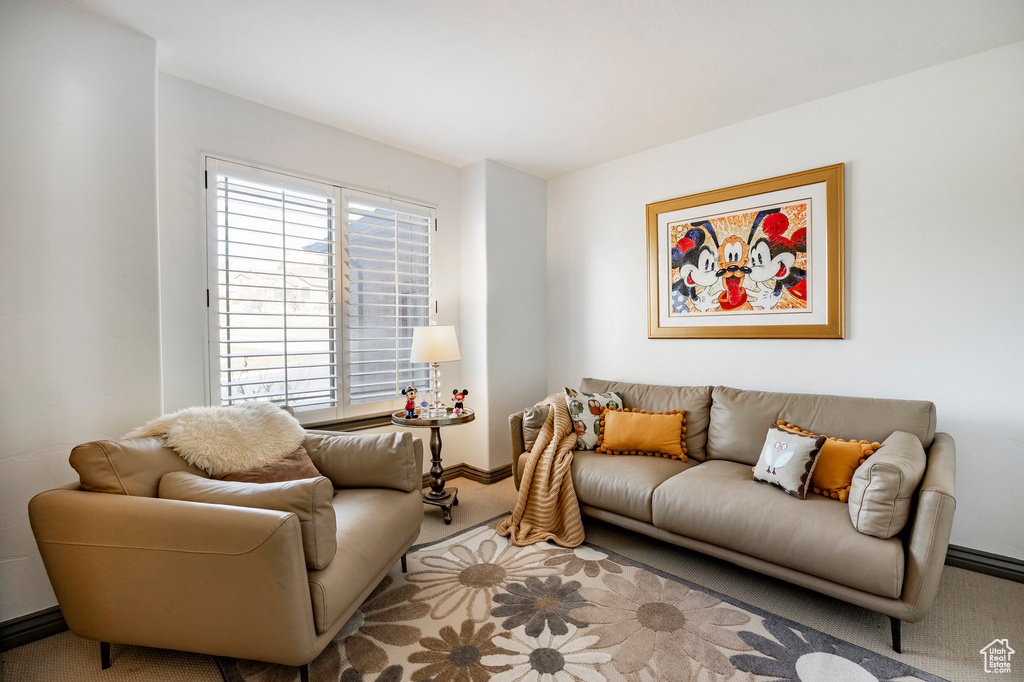 Living area with light carpet and baseboards