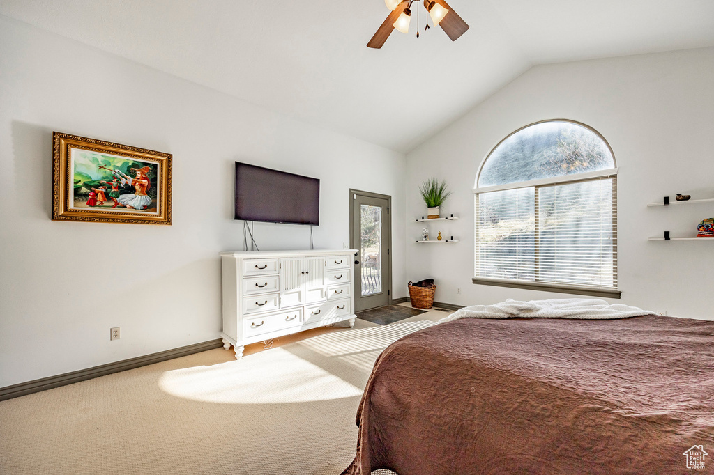Carpeted bedroom with access to exterior, vaulted ceiling, baseboards, and ceiling fan