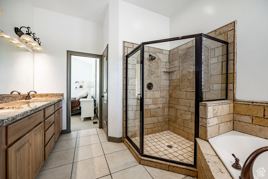 Full bath featuring a stall shower, a garden tub, connected bathroom, and tile patterned flooring