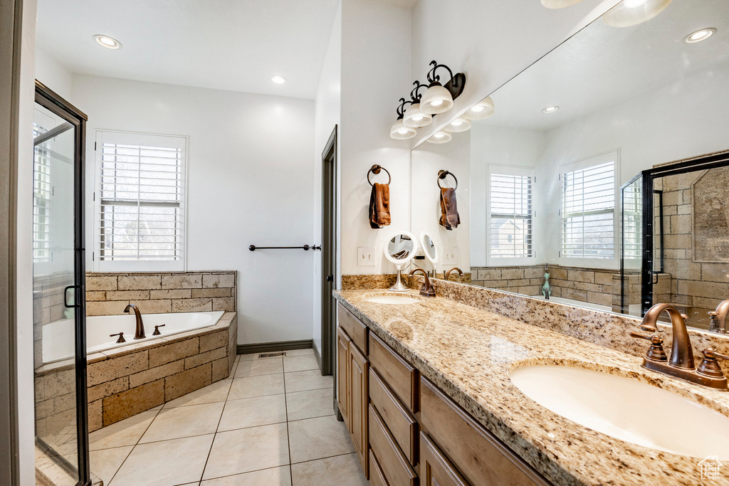 Full bathroom with a garden tub, a shower stall, double vanity, tile patterned flooring, and recessed lighting