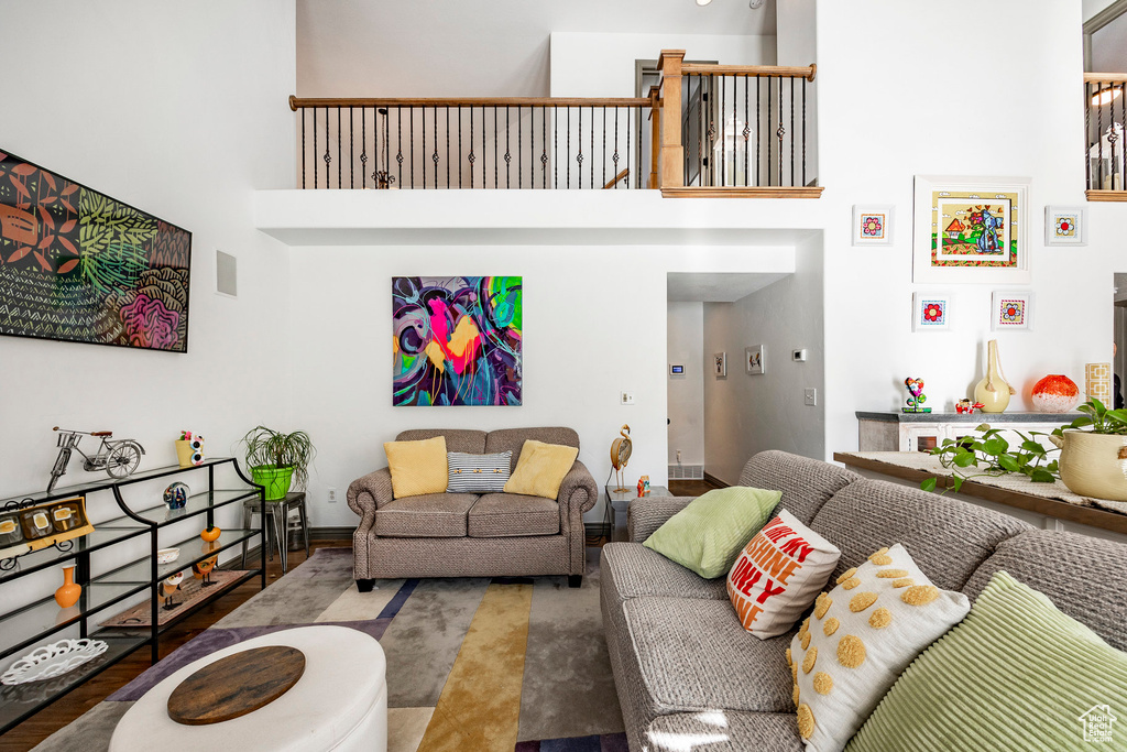 Living room featuring a high ceiling and baseboards