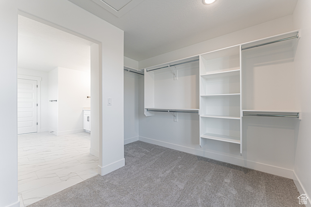 Spacious closet with marble look tile flooring