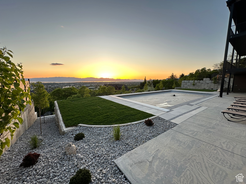 Fenced backyard featuring a mountain view and a patio