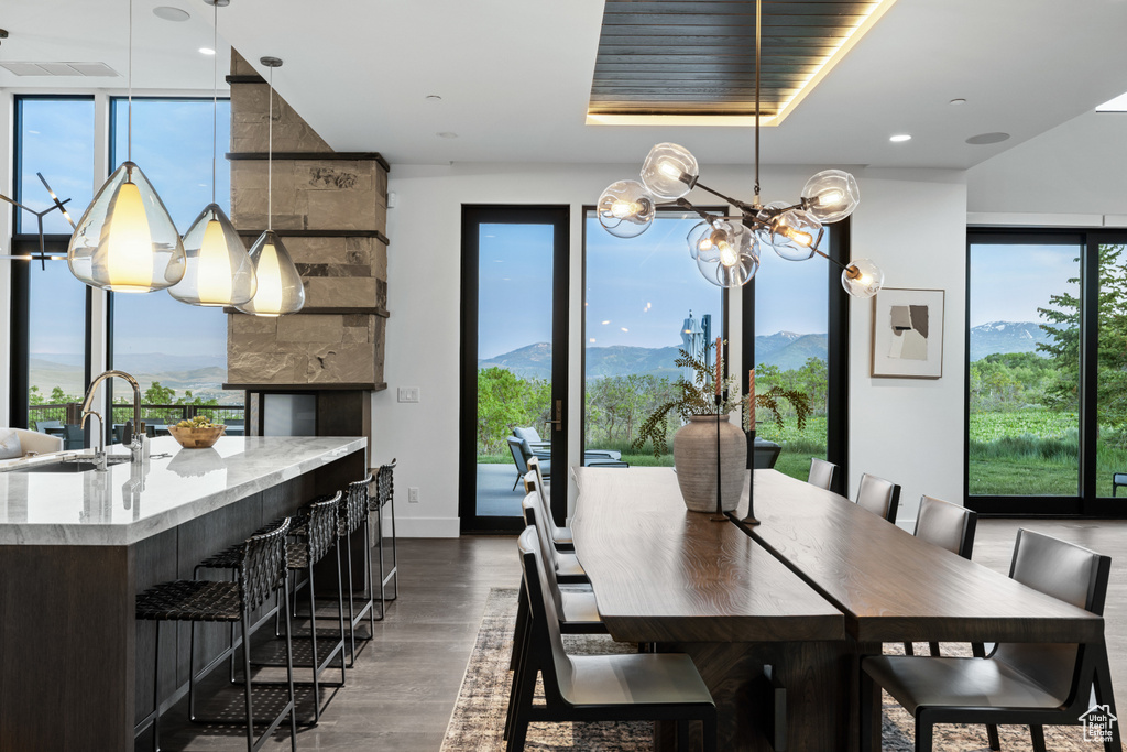Dining area featuring wood finished floors, a chandelier, and a mountain view