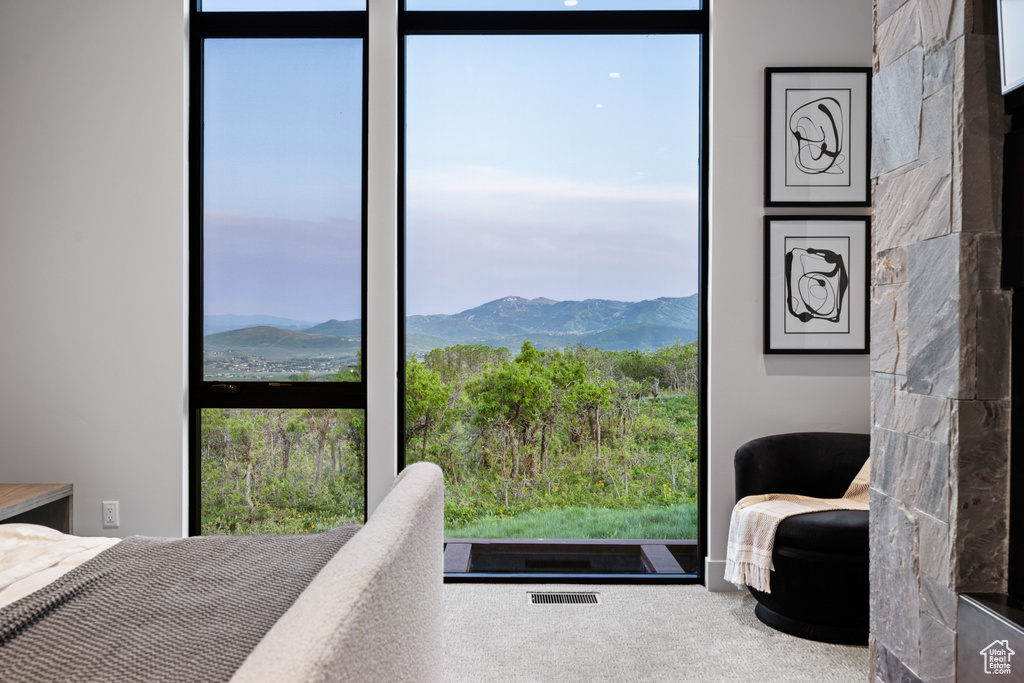 Bedroom featuring multiple windows, a mountain view, and carpet