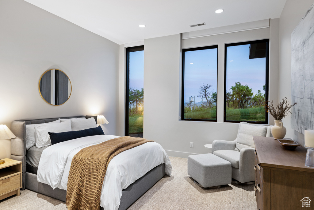 Bedroom with light carpet, multiple windows, recessed lighting, and baseboards