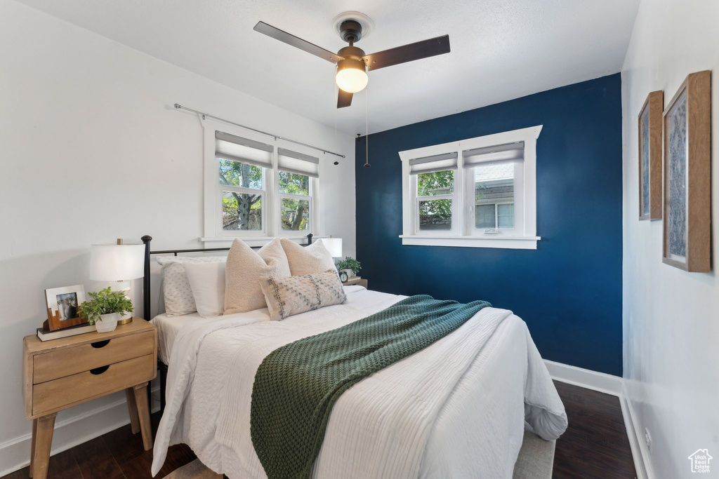 Bedroom with baseboards, a ceiling fan, and wood finished floors
