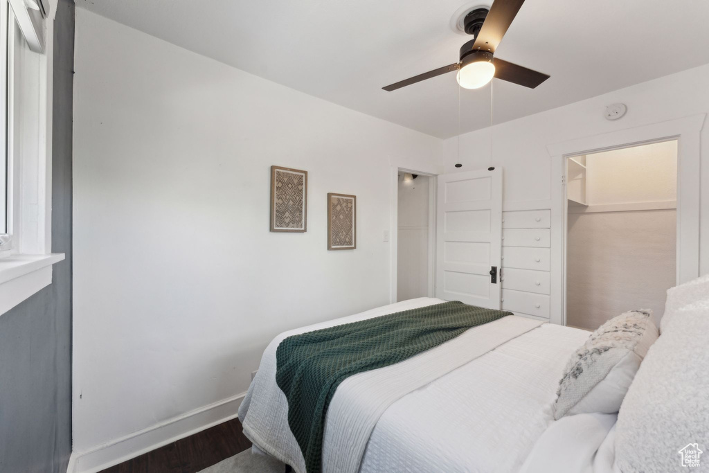 Bedroom featuring baseboards, ceiling fan, and wood finished floors