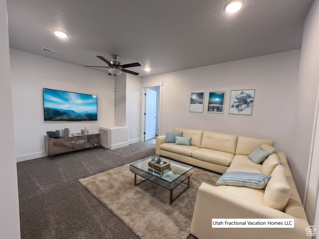 Carpeted living area featuring visible vents, recessed lighting, baseboards, and ceiling fan