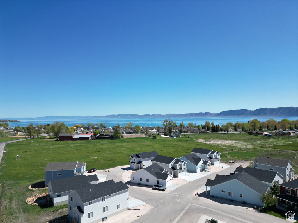 Drone / aerial view featuring a water and mountain view