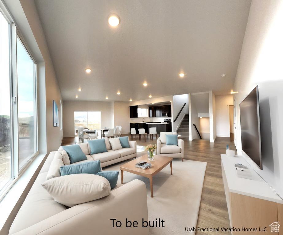 Living room featuring stairway, recessed lighting, and wood finished floors