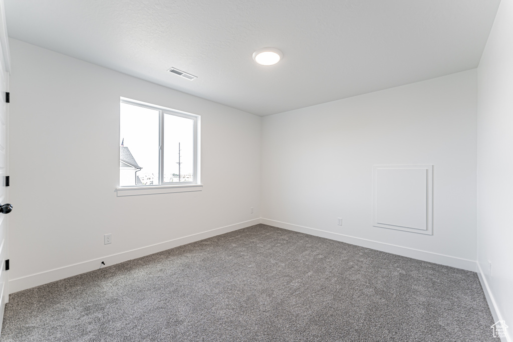Unfurnished room with carpet floors
