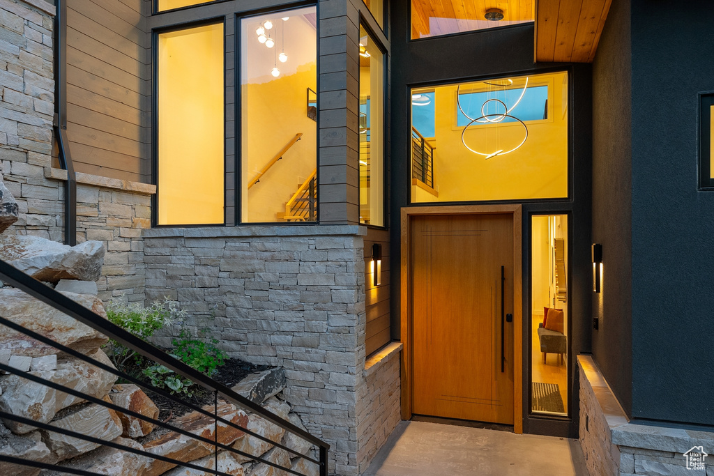 Doorway to property with stone siding