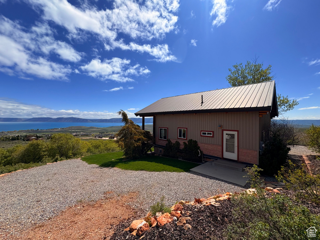 Rear view of property with a mountain view and brick siding