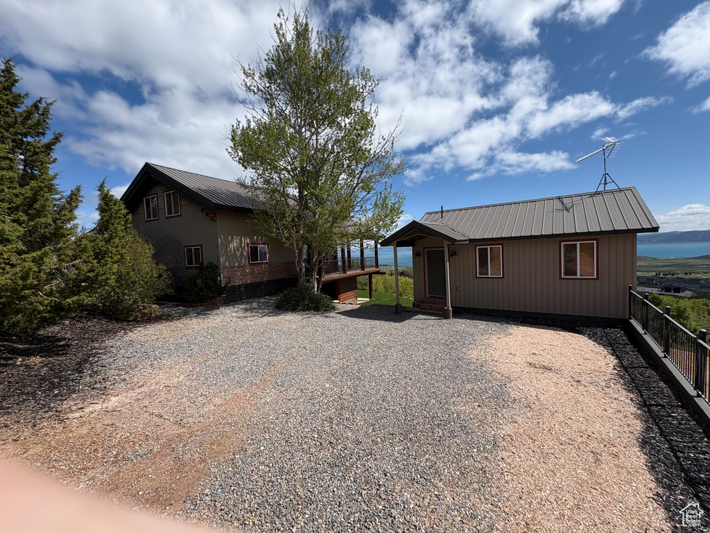 View of front of house featuring metal roof and driveway