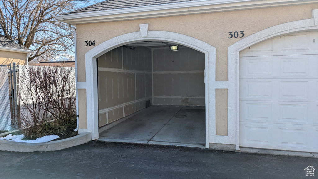 Garage featuring fence