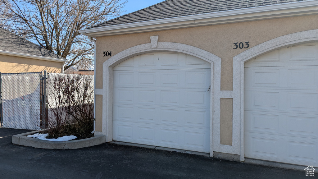 Garage featuring fence