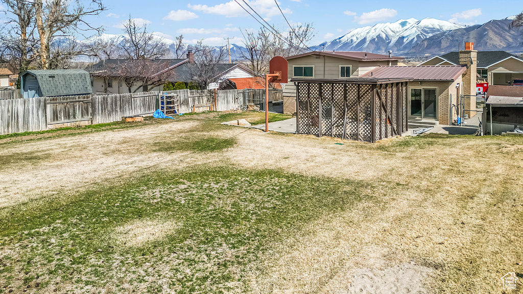 View of yard featuring a mountain view, a fenced backyard, and a patio area