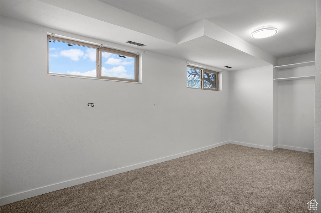 Basement with baseboards and carpet flooring