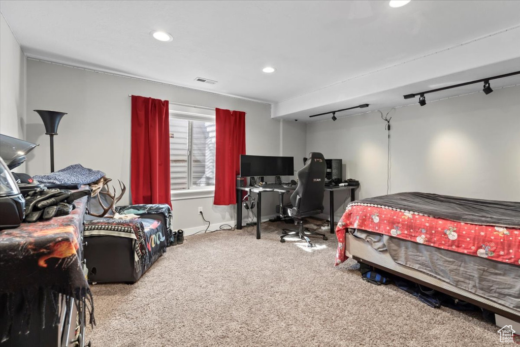 Carpeted bedroom featuring track lighting, recessed lighting, visible vents, and baseboards