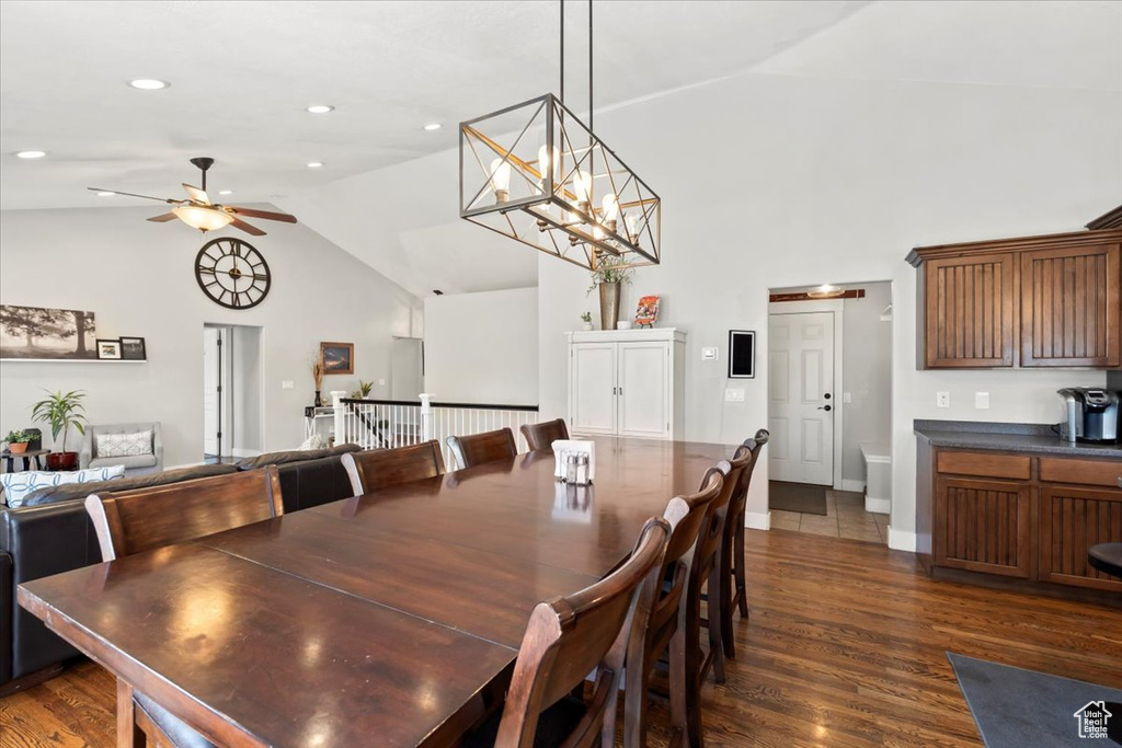 Dining space with recessed lighting, a ceiling fan, high vaulted ceiling, and dark wood-style flooring