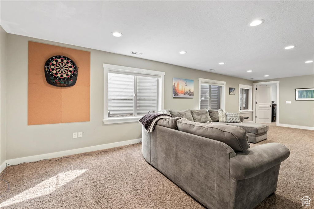 Living room featuring recessed lighting, visible vents, baseboards, and light colored carpet