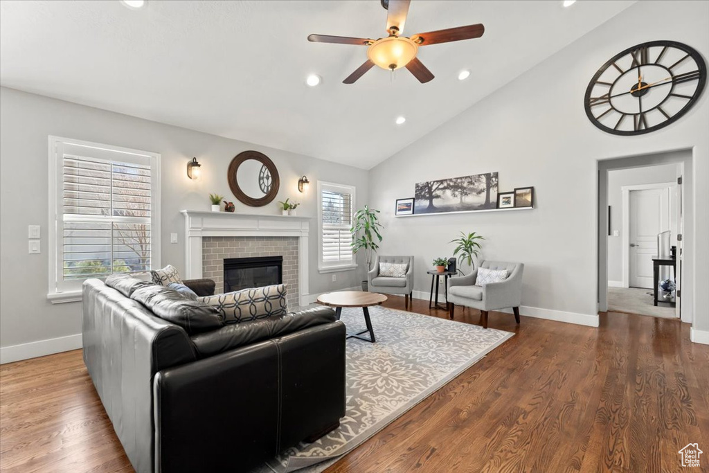 Living area with wood finished floors, recessed lighting, a fireplace, baseboards, and ceiling fan