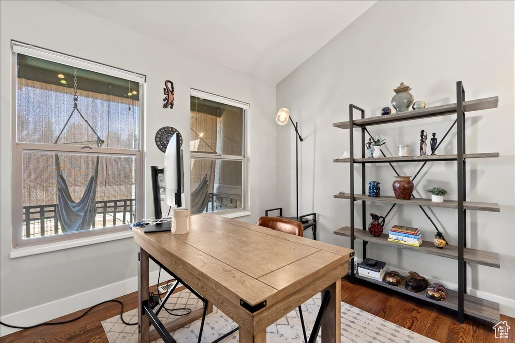 Home office with baseboards and wood finished floors