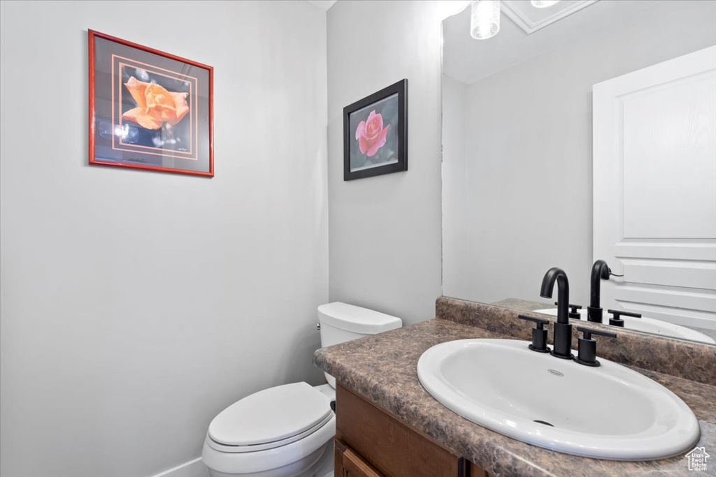 Half bathroom with toilet and vanity