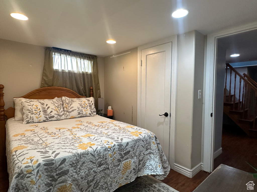 Bedroom with recessed lighting, wood finished floors, and baseboards