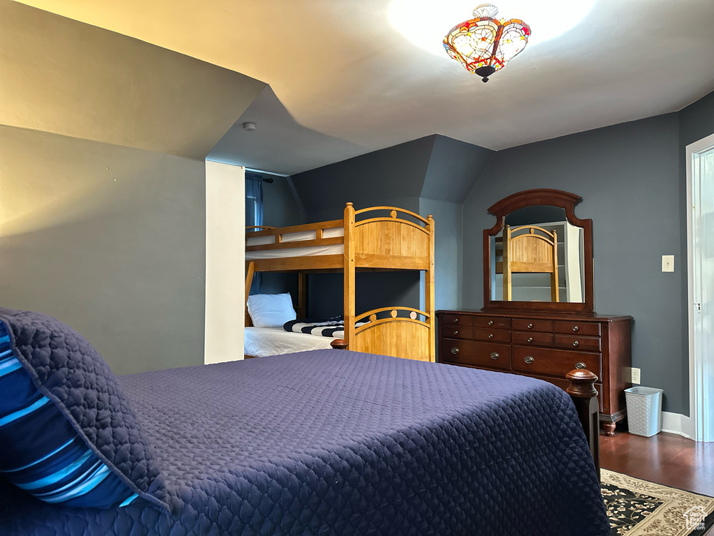 Bedroom with vaulted ceiling and wood finished floors