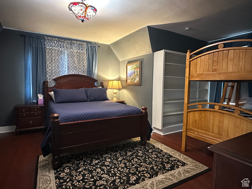 Bedroom featuring lofted ceiling and wood finished floors