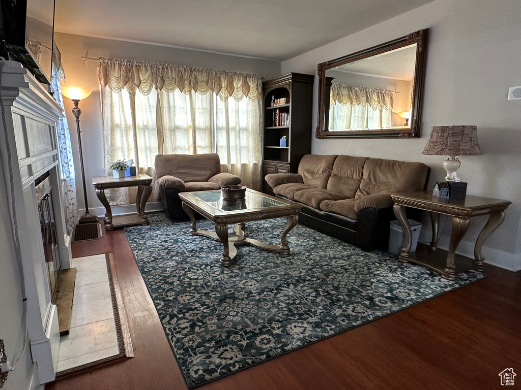 Living area with a tile fireplace and wood finished floors