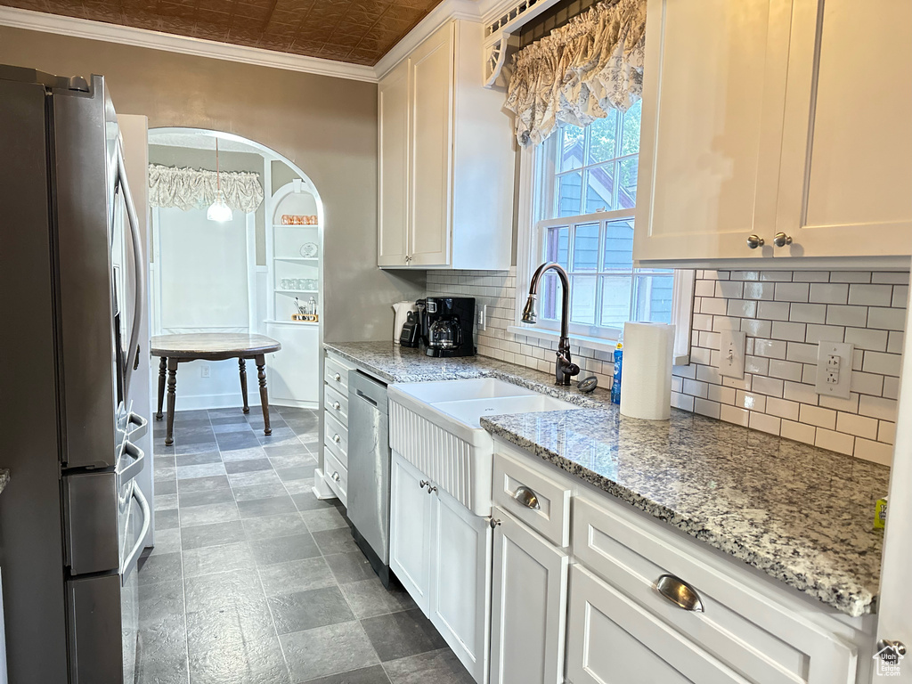 Kitchen featuring tasteful backsplash, ornamental molding, an ornate ceiling, stainless steel appliances, and a sink