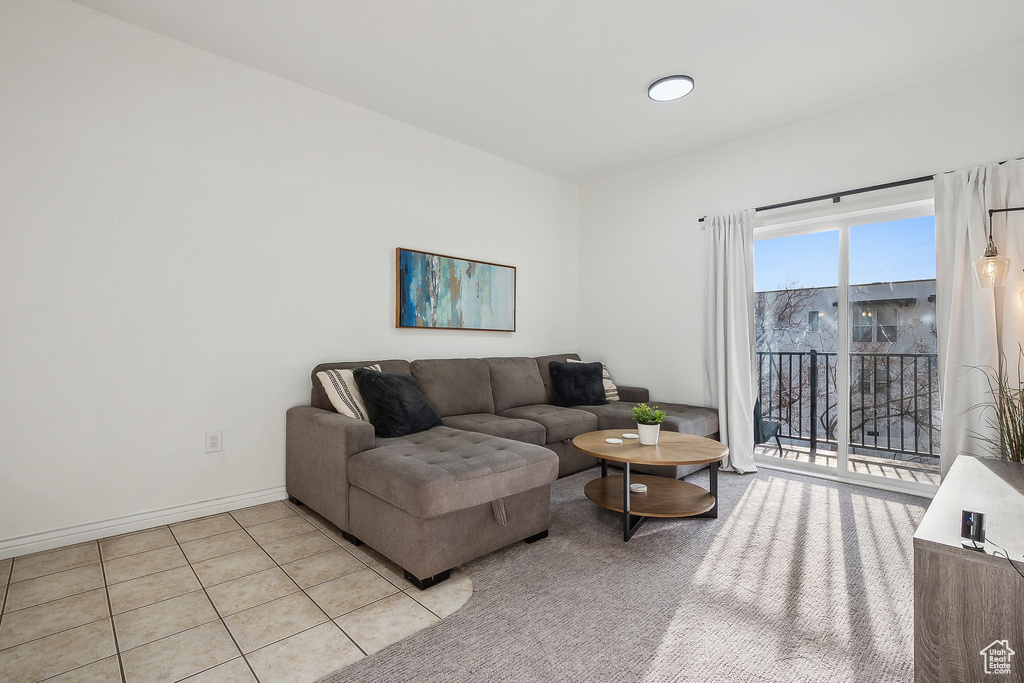 Living area featuring light tile patterned floors and baseboards
