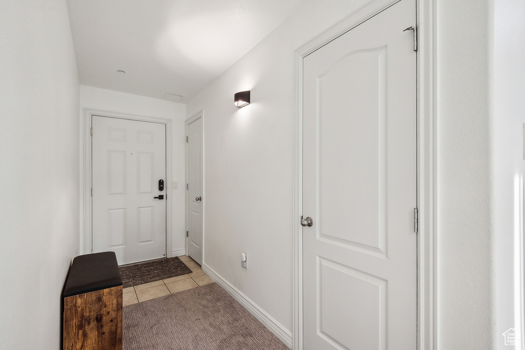 Interior space featuring light tile patterned floors and baseboards