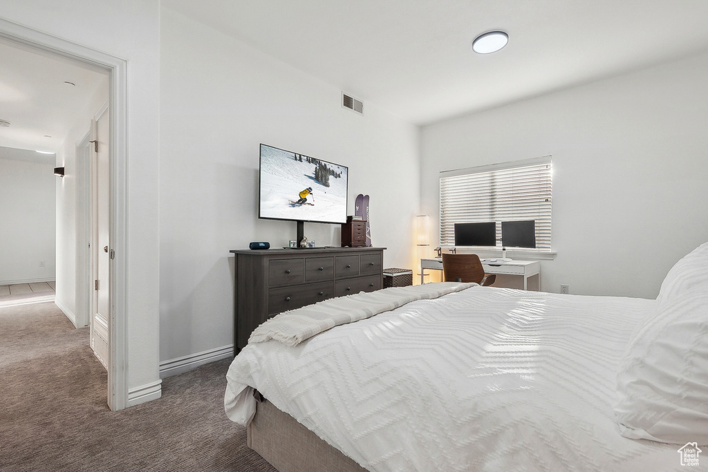 Bedroom with visible vents, baseboards, and carpet floors